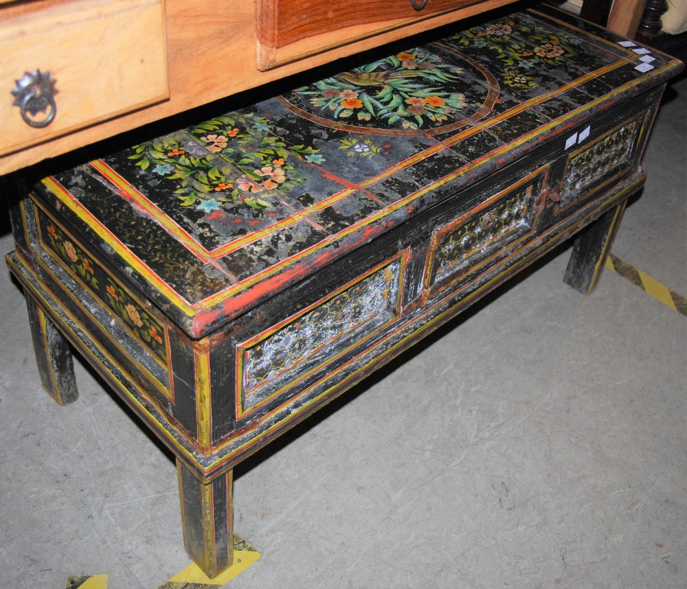 AN EASTERN PAINTED WOOD RECTANGULAR COFFEE TABLE WITH SINGLE HINGED CUPBOARD DOOR TO THE FRIEZE,