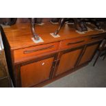 A MID-CENTURY "G PLAN" TEAK DROP-LEAF DINING TABLE, FOUR CHAIRS AND SIDEBOARD