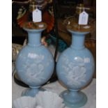 A PAIR OF OPAQUE BLUE GLASS VASES WITH WHITE ENAMELLED FLORAL DECORATION CONVERTED TO A PAIR OF