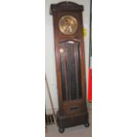 AN ART DECO STYLE STAINED OAK LONGCASE CLOCK WITH CIRCULAR BRASS DIAL WITH ARABIC NUMERALS,