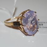 A 9CT GOLD RIO GRANDE LAVENDER QUARTZ AND RED DIAMOND RING, CENTRED WITH AN OVAL CUT RIO GRANDE