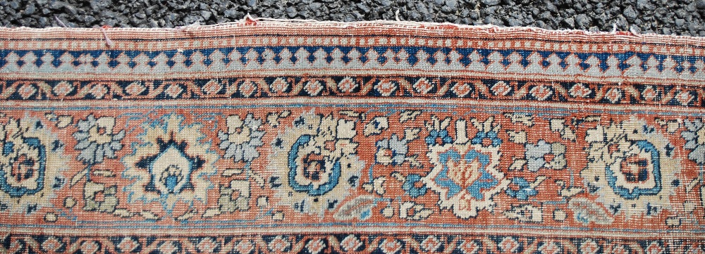 AN ANTIQUE PERSIAN CARPET, THE MADDER FIELD WITH PALMETTES AND SCROLLING FLORAL ARABESQUES WITH A - Image 8 of 9