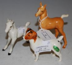 THREE BESWICK ANIMAL FIGURES TO INCLUDE TWO FOALS AND A JACK RUSSELL.