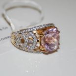 AN 18CT GOLD KUNZITE AND DIAMOND RING, CENTRED WITH A CUSHION CUT KUNZITE ESTIMATED TO WEIGH 9.