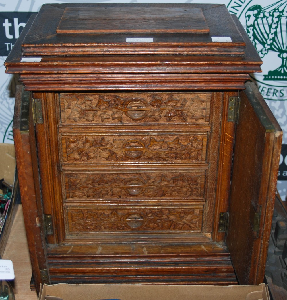 A CARVED OAK TABLE TOP CABINET IN THE GOTHIC TASTE, TWO CUPBOARD DOORS OPENING TO FOUR DRAWERS - Image 2 of 2