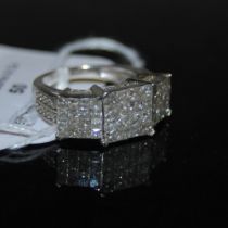 A 9CT WHITE GOLD AND DIAMOND TOMAS RAE RING, CENTRED WITH A RECTANGULAR PANEL ENCLOSING SIXTEEN