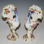 A PAIR OF DECORATIVE POTTERY PEACOCKS