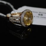 A 9CT GOLD LEMON CITRINE AND DIAMOND LEHRER TORUSRING, CENTRED WITH ONE SMALL ROUND CUT DIAMOND