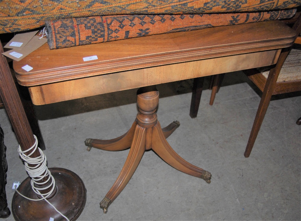 A REPRODUCTION REGENCY STYLE MAHOGANY PEDESTAL GAMES/ CARD TABLE