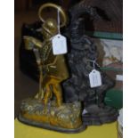A CAST IRON PUNCH AND JUDY DOORSTOP, TOGETHER WITH ANOTHER BRASS DOOR STOP IN THE FORM OF A PORTLY