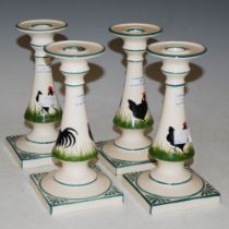 SET OF FOUR GRISELDA HILL POTTERY CANDLESTICKS DECORATED WITH BLACK COCKERELS