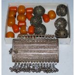 A MIDDLE EASTERN WHITE METAL AMULET BOX AND COVER WITH TASSLE DETAIL, SIX WHITE METAL BALLS AND A