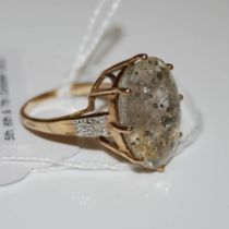 A 9CT GOLD ASTRAEOLITE AND DIAMOND RING, CENTRED WITH OVAL CUT ASTRAEOLITE ESTIMATED TO WEIGH 16.