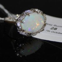 AN 18CT WHITE GOLD AUSTRIALIAN OPAL AND DIAMOND RING, CENTRED WITH AN OVAL CUT WHITE OPAL
