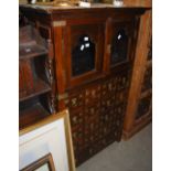 AN EASTERN STAINED WOOD AND BRASS BOUND SIDE CABINET, FITTED WITH PAIR OF GLAZED CUPBOARD DOORS OVER