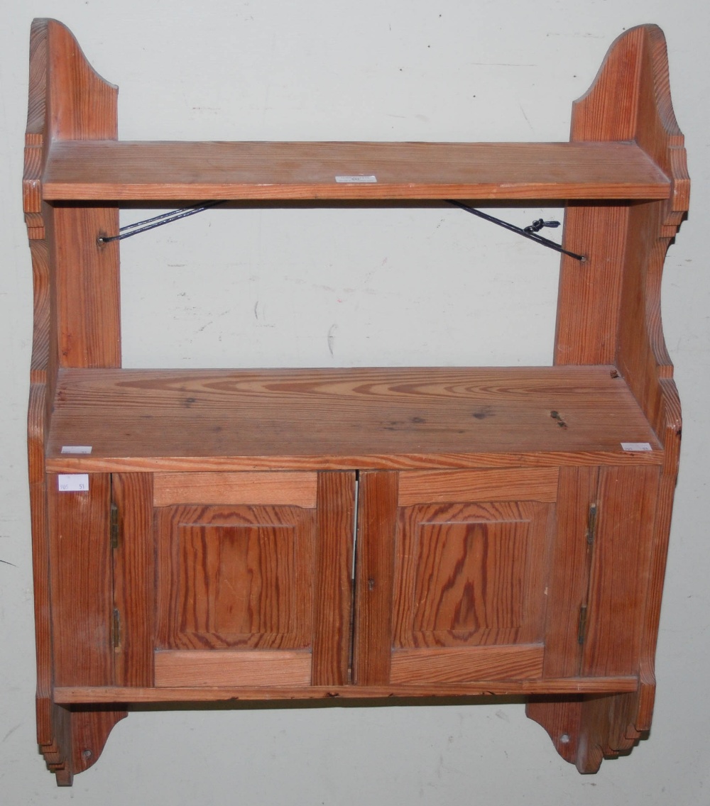 A PITCH PINE HANGING SHELF WITH TWO CUPBOARD DOORS