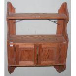 A PITCH PINE HANGING SHELF WITH TWO CUPBOARD DOORS