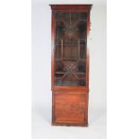 A 19TH CENTURY MAHOGANY BOOKCASE/ ESTATE CABINET, TOPPED BY A PEDIMENT WITH CARVED ROUNDELS OVER A