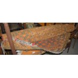 GROUP OF FOUR PERSIAN RUGS, TO INCLUDE A BLACK AND ORANGE RUG WITH CENTRAL RECTANGULAR DECORATED