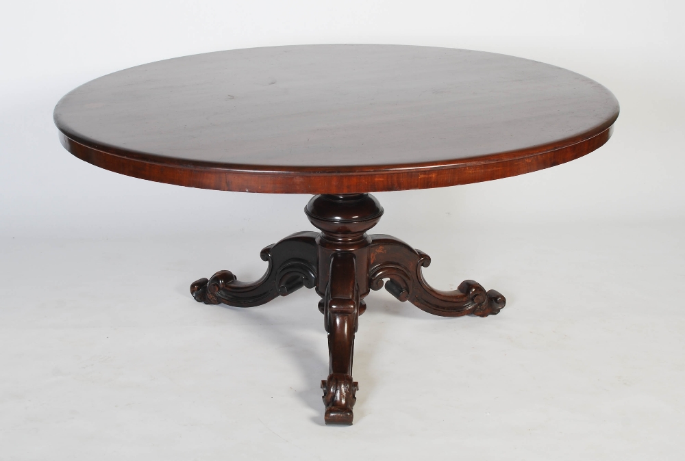 A VICTORIAN MAHOGANY CENTRE TABLE, THE OVAL SHAPED TOP RAISED ON A TURNED CYLINDRICAL SUPPORT ON