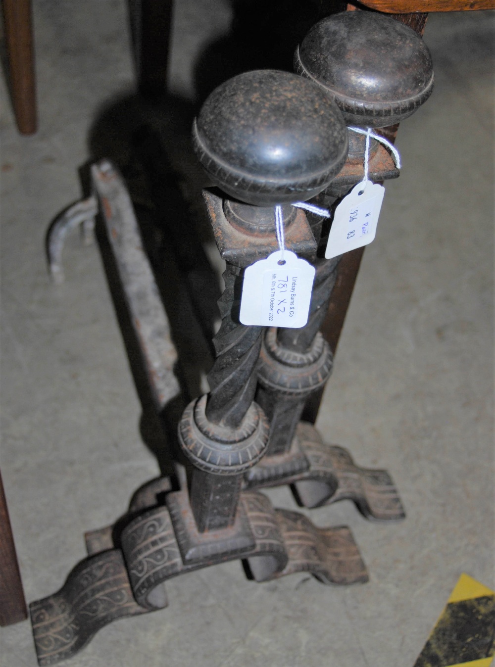 A PAIR OF METAL ANDIRONS WITH SPIRAL TWIST DETAIL