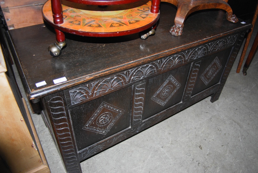 A LATE 19TH / EARLY 20TH CENTURY STAINED OAK COFFER WITH TRIPLE PANEL FRONT