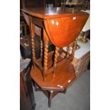 A 20TH CENTURY STAINED OAK DROP LEAF TABLE ON BARLEY TWIST SUPPORTS, TOGETHER WITH AN OCTAGONAL