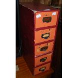 A RED AND ORANGE PAINTED TABLE TOP CHEST OF FIVE DRAWERS