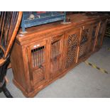 AN EASTERN CARVED WOOD SIDEBOARD, SET WITH SIX CUPBOARD DOORS
