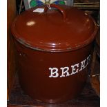 A BROWN ENAMEL BREAD BIN AND COVER