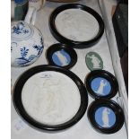 A PAIR OF FRAMED BISQUE PORCELAIN PANELS OF CIRCULAR SHAPE, THREE BLUE GROUND JASPER WARE PANELS AND