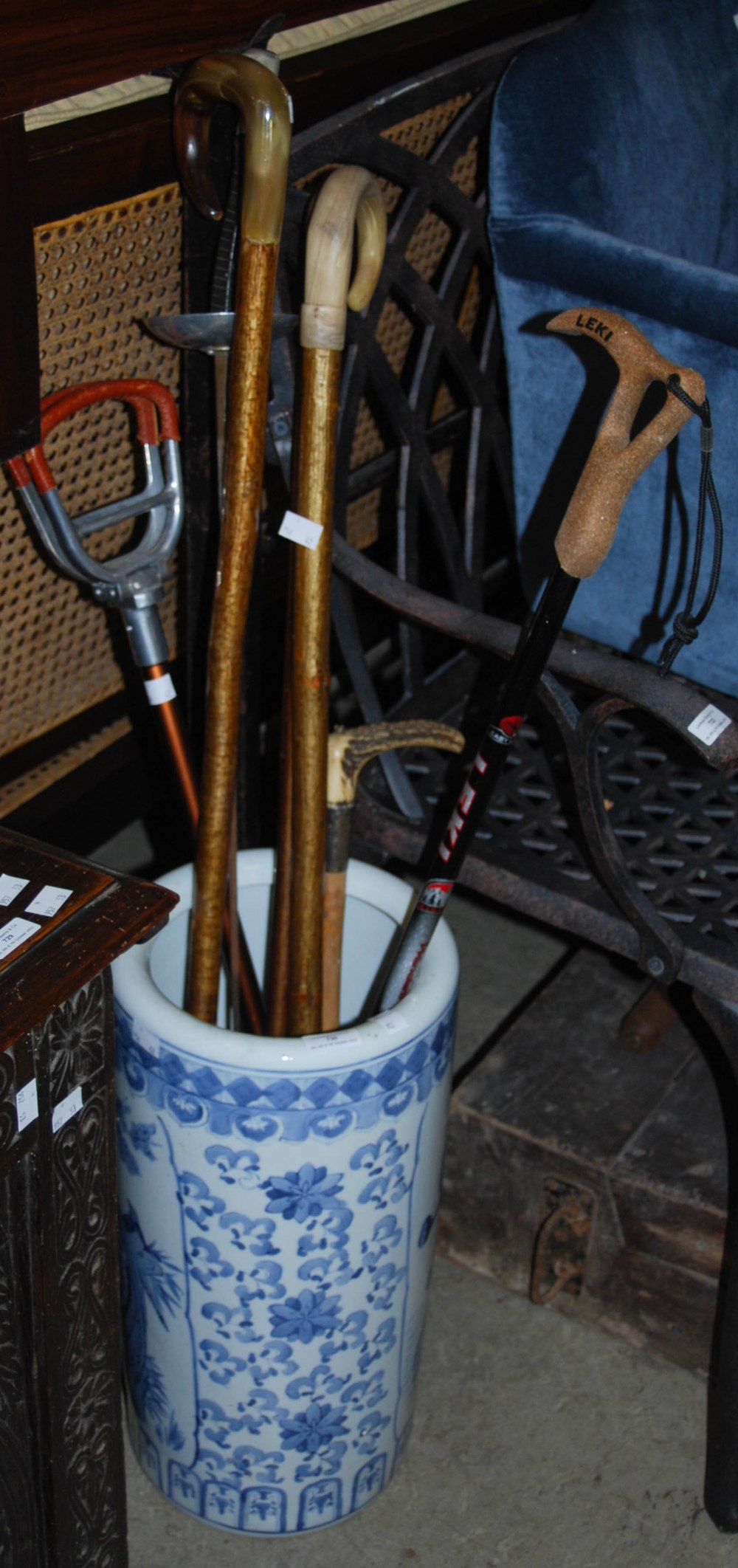 A BLUE AND WHITE CERAMIC STICK / UMBRELLA STAND, DECORATED WITH BIRDS AND MIXED FOLIAGE, TOGETHER