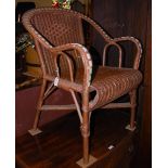 AN EARLY 20TH CENTURY CANEWORK ARMCHAIR WITH GREEN AND WHITE WOVEN LINE DETAIL