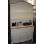 A PAINTED PINE DRESSER, THE BASE WITH THREE LONG DRAWERS ABOVE THREE CUPBOARD DOORS, THE UPPER