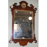 A GEORGIAN STYLE MAHOGANY WALL MIRROR WITH FRET-CUT DETAILS AND FLORAL SURMOUNT, APPROX. 82CM HIGH X