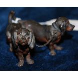 A COLD PAINTED BRONZE FIGURE GROUP OF TWO DACHSHUNDS