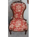 A VICTORIAN WALNUT PARLOUR CHAIR ON TAPERED FLUTED SUPPORTS WITH WHITE CERAMIC CASTERS