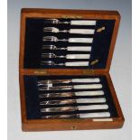 AN OAK-CASED SET OF SIX MOTHER-OF-PEARL HANDLED FRUIT KNIVES AND FORKS
