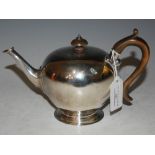 A LATE 19TH CENTURY LONDON SILVER BULLET SHAPED TEAPOT WITH CARVED WOOD HANDLE AND FINIAL, GROSS