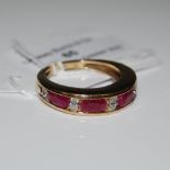 A 9CT GOLD BURMESE RUBY AND DIAMOND RING, SET WITH FOUR VARIOUS CUSHION CUT BURMESE RUBIES ESTIMATED