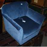 A BLUE UPHOLSTERED CHILDS ARMCHAIR WITH HINGED SEAT CUSHION, OPENING TO SMALL STORAGE SPACE