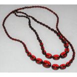 TWO GRADUATED RED AMBER TYPE NECKLACES, GROSS WEIGHT 145 GRAMS
