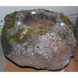 A QUERN-STONE OF CIRCULAR FORM, APPROX. 36CM HIGH X 50CM WIDE