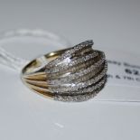 A 14CT GOLD OVERLAY STERLING SILVER AND DIAMOND SET RING, SET WITH VARIOUS ROUND AND BAGUETTE CUT