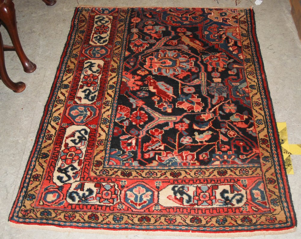 A PERSIAN RUG FRAGMENT OF ASYMMETRIC DESIGN, APPROX 127CM X 102CM