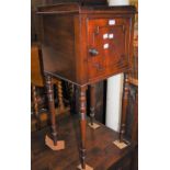 A 19TH CENTURY MAHOGANY POT CUPBOARD WITH SINGLE CUPBOARD DOOR, RAISED ON FOUR TURNED SUPPORTS