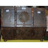 A CARVED WOOD AND METAL BOUND ARCHITECTURAL FORM TABLE CASKET