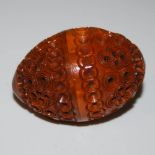 SEWING INTEREST: A LIGNUM VITAE SEWING EGG WITH PIERCED AND CARVED DETAIL