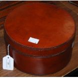 A CYLINDRICAL BROWN LEATHER STORAGE BOX AND COVER