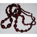 THREE ASSORTED RED AMBER TYPE BEAD NECKLACES AND A SIMILAR BEAD BRACELET
